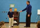 West Penn Elementary student James Akins looks on with trepidation as magician Joe Holiday offers an undersized replacement shoe after accidently "burning" his original one during the act. The "burned" shoe magically reappeared, unscathed, at the…
