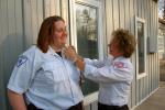 KAREN CIMMS/TIMES NEWS Joni Gestl, right, administrator of the Lehighton Ambulance Association, pins a stork onto Kate McGinley's collar, in recognition of McGinley's assistance in delivering newborn Andrew Michael Walton. The baby is the son of…