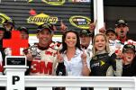 MIKE FEIFEL/TIMES NEWS Greg Biffle stands at left in Victory Lane with the Sunoco Red Cross Pennsylvania 500 trophy with crew members and Sprint Cup officials after winning the 200 lap race at Pocono Raceway.