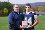 Northern Lehigh senior linebacker/fullback Matt Gill is congratulated by head coach Joe Tout after receiving the TIMES NEWS Football Player of The Week award. Gill topped the Bulldogs in tackles with 10 in leading his team to a shutout win over…