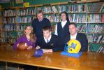 Ron Gower/TIMES NEWS Marian's Dominick Richards, center, signs letter committing himself to James Madison University. Seated with him are his parents, Jeanette and Ralph Richards. Looking on are his high school football coach Stan Dakosty and the…