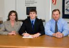 Bob Ford/TIMES NEWS Northern Lehigh's Matt Gill, center, signs a letter of intent to continue his academic and athletic careers at Lafayette College. With Gill are his parents, Karen and Jack.