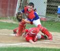 RON GOWER/TIMES NEWS Jim Doerr of Lansford is safe after sliding into home while looking on is Jim Thorpe catcher Brandon Carroll in Babe Ruth All-Star baseball action last night.