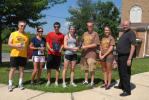 RON GOWER/TIMES NEWS Nathan Halenar, third from left, makes presentation of awards to top finishers in the 12th annual 2 Saints Scamper held in Summit Hill, Saturday. Halenar was co-chairman of the event. Winners are, from left, Tom Lager of Jim…
