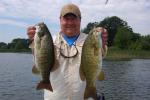 Rich Balliet of Nesquehoning prepares to release a pair of lunker smallmouth bass caught on the St. Lawrence River during a recent outing at Caiger's 1000 Islands Resort.