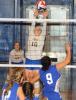 Ron Gower/TIMES NEWS Marian's Joanna Batula taps the ball over the net against Minersville in volleyball action last night. In the background is teammate Lauren Nietz.