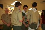 KAREN CIMMS/TIMES NEWS Scouts from Boy Scout Troop 555 place a white neckerchief on new Eagle Scout Tyler McGeehan, center, during his Eagle Scout Court of Honor Ceremony. At left is Scoutmaster Ray Attewell.