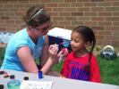 SPECIAL TO THE TIMES NEWS Parent volunteer Sandy Buskirk paints a flower on the cheek of Pre-K student Katherine Morris. Katherine is wearing one of the t-shirts that the PTA gave to every child in the school.