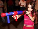 ANDREW LEIBENGUTH/TIMES NEWS Emily Hartranft, 8, takes aim with a marshmallow gun during the East End Fire Company's community block party held over the weekend.