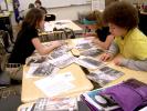 From left are Skylar Francesco, McKenzie Lazar and Crystal Nase as they examine several Civil War era photographs during the Traveling Trunk program at Panther Valley Middle School.
