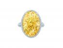 This image released by Tiffany's shows a 15.04ct Oval Fancy Vivid Yellow Diamond Ring with white diamonds and set in platinum and 18k yellow gold. (AP Photo/Tiffany's)