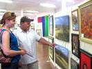 CAJETAN BERGER/SPECIAL TO THE TIMES NEWS David Eubanks, Lehighton, and Heather Walbridge, Coopersburg, tour the art on display Sunday at the Carbon County Art League's 32nd annual gallery in Jim Thorpe.