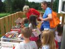 CAJETAN BERGER/SPECIAL TO THE TIMES NEWS ABOVE: Children from the Discovery Years day care center browse the children's section of the used book sale at he Penn-Kidder Library Center grand opening on Friday. BELOW: Michelle Ress, 34, right, and…