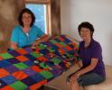 AL ZAGOFSKY/SPECIAL TO THE TIMES NEWS Lisa Krouse (left) Claudette Gosselin, two of the Mahoning Valley Fiber Guild founders with a quilt made by Krouse, a former arts teacher. The quilt features "yo-yos" pieces of circular fabric that are drawn in,…