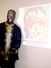 JUDY DOLGOS-KRAMER/SPECIAL TO THE TIMES NEWS Ibiyinka Olufemi Alao poses with a slide depicting his self-portrait.