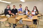 AMY MILLER/TIMES NEWS Five members of the Future Business Leaders of America chapter at Panther Valley High School look over just a few of the boxes of food items collected by the students during a recent food drive. The food was then distributed to…