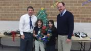 SPECIAL TO THE TIMES NEWS Henry Desrosiers, director of the Carbon County Veterans Affairs office, right, accepts a homemade wreath from Annabella Redline and Dakota Naimon, two students from the fourth-grade class of Leo O'Donnell, left. Annabella…