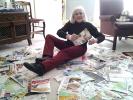 @$:SPECIAL TO THE TIMES NEWS Kitty Bartholomew of Lehighton poses with just some of the thousands of coupons she has clipped. The coupons are sorted and then sent to active duty military members and their families.