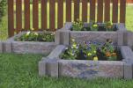 Courtesy of Infinity Lawn and Garden Incorporating raised flower beds using stone planters can beautify the landscape without taking a lot of time or effort.