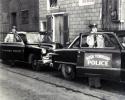 ROY ACKERMAN PHOTO 1954: Rush Township Police Chief William Klotz, right, demonstrates a two-way radio with Tamaqua patrolman Harry Dornblaser. The historic image was taken on Aug. 1, 1954, on West Rowe Street near the Tamaqua police station.