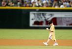 A youngster who's battled cancer smiles as he walks off the field with an autographed baseball from a Arizona Diamondback before the Diamondbacks game with the San Diego Padres, Saturday, Sept. 13, 2014, in Phoenix. (AP Photo/Darryl Webb)