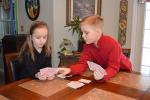 @$:KAREN CIMMS/TIMES NEWS Sadie Strack, 7, and her brother, Richie, 10, enjoy playing card games on snow days. They are the children of Rich and Stacie Strack of Penn Forest Township.