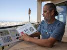 Henk Rogers, who manages the worldwie rights to the video game Tetris, displays a book he published to try to persuade Hawaii lawmakers to change policy on energy independence, Tuesday, June 30, 2015 at his off-grid home in Honolulu. Rogers is…