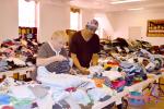 KAREN CIMMS/TIMES NEWS Mary Strohl and William Neives look over some of the baby clothes donated for the 17th annual clothing giveaway at St. John's Lutheran Church in Jim Thorpe. The event starts at 9 a.m. Thursday.