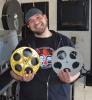 Virgil Cardamone, a movie booker with Mahoning Drive-In Theater in Lehighton, shows off a couple reel-to-reel films.