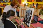 Artist instructor Tammy Leaver instructs Amanda Wensel during Tuesday night's special pet paint and sip class. KELLEY ANDRADE/TIMES NEWS