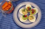 Stuffed eggs with tuna, topped with dill, and guacamole, topped with tomatoes. AP VIA SARA MOULTON Copyright - Sara Moulton