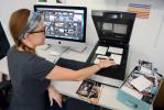 Imaging specialist Erin McClintic works in the lab at Phototronics in Winnetka, Illinois, digitizing and archiving a shoe box of customer photographs, right. PHOTOTRONICS VIA AP