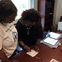 Theresa and Romona engaged in train-the trainer for self-breast exam