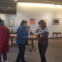Cathy Mielke and Chris Jackson near registration table