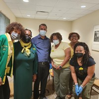 Rho Chi Chi members with the pharmacist. He supplied the vaccines.