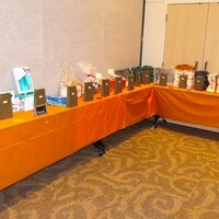 Bags ready and tables displaying the auction items ready for tickets from members .