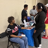 Ronesha talking to an attendee 