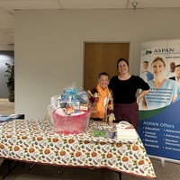 Stephanie Johnson and Meg Beturne with Coffee basket containing Keurig assorted coffees and gifts donated by Meg.  Won by Lisa D'Angelo