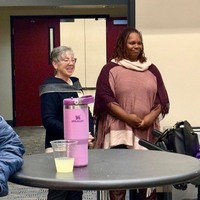Deborah Shelton and LaToya Duckworth watch the meeting proceedings.