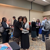 Patricia Blair and Louise Reagan, 2 of the ACNA co-founders greet each other.