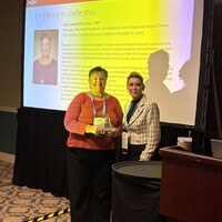 Judy Cowell, BSN, R.N., C-NPT accepting the Excellence in Leadership award 