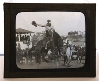 Glass Slide - Cowboy holding a hat while saddle bronc riding 