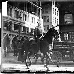 Mounted policeman riding a horse on a street in the Loop
