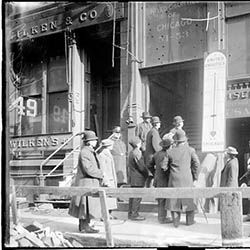 Men looking at the United Charities thermometer posted outside their offices