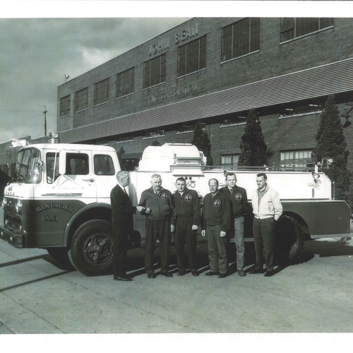 Avon Fire Department buying new fire truck.  Photo taken at John Bean FMC Corporation in Lansing, Michigan in 1962.  L to R: FMC Instructor DE Johnston, AFD Cyril Miller, Del Kempf, Don Casper, Bob Buck, and Paul Hogrefe.