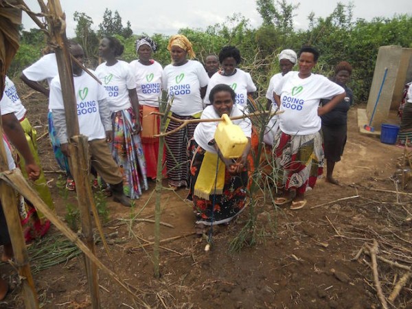 Winnie and a group of women at a tippy tap, a hands-free, foot-lever-operated hand washing station. (Photo credit: Sundara)