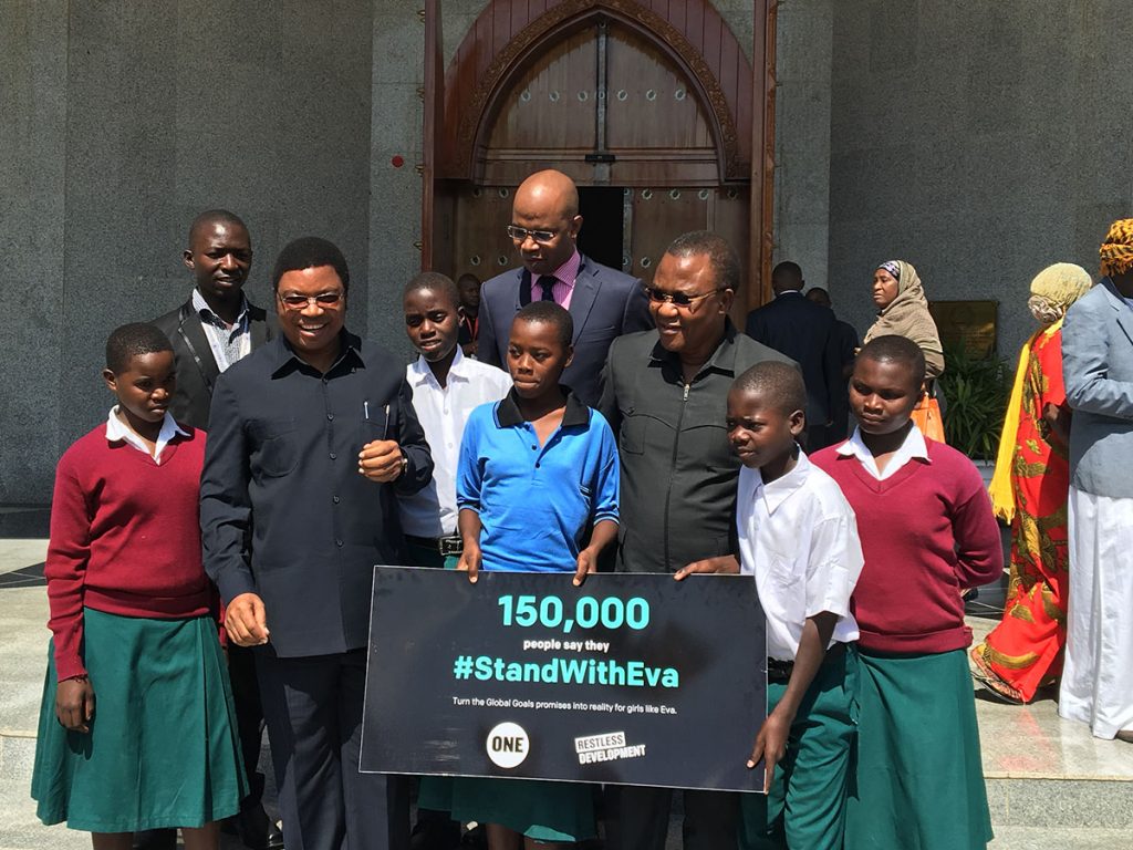 Eva Tolage, center, with PM Kassim Majaliwa; local MP William Lukuvi; January Makamba, MP and minister for Union Affairs and Environment; classmates; teacher Dennis Myovela. (Photo credit: Restless Development)