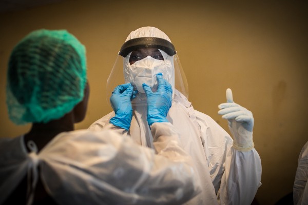 Health workers in Guinea take protective measures against Ebola.