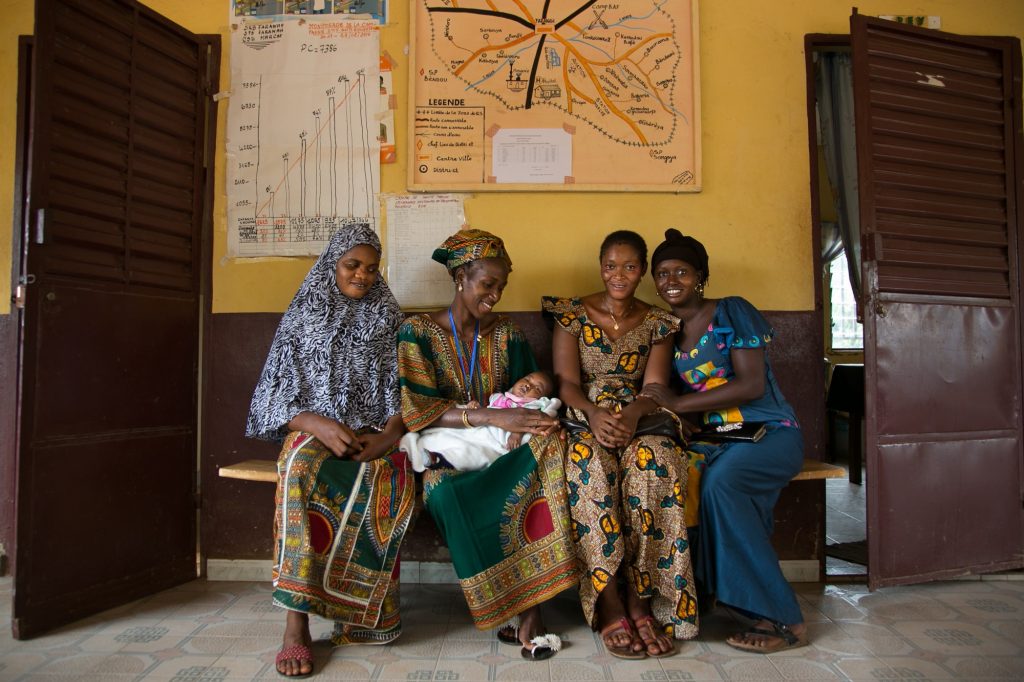 Women wait at a health center in Faranah, Guinea.