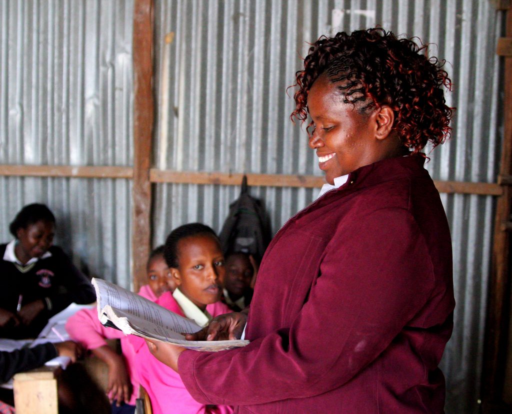 Jennifer teaching at the front of a City Shine classroom.